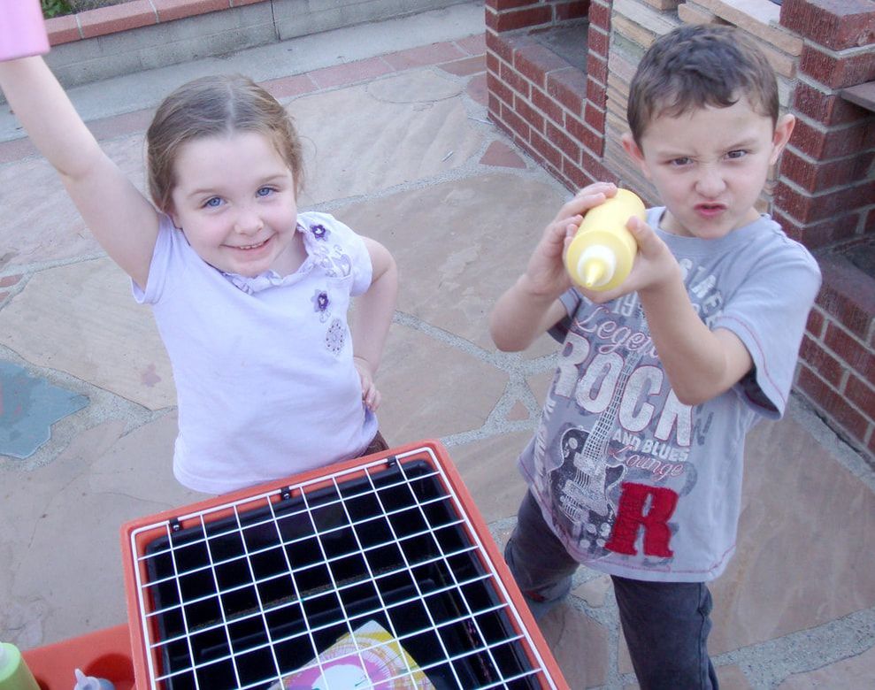 two kids having fun at a spin art party in Los Angeles